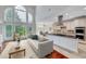 Elegant living room open to a kitchen featuring a large window and neutral colors at 404 Vintage Hill Cir, Apex, NC 27539