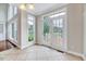 Bright sunroom filled with natural light, features a door leading to the outdoor deck at 404 Vintage Hill Cir, Apex, NC 27539