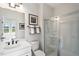 Bathroom featuring a glass-enclosed shower, white vanity with countertop, and framed artwork at 408 Rowe Way, Knightdale, NC 27545
