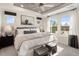 Bright bedroom with white walls and ceiling fan, featuring two large windows with black-out shades and natural light at 408 Rowe Way, Knightdale, NC 27545