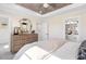 Spacious bedroom with ensuite bath, complete with wood dresser, round mirror and stylish decorative accents at 408 Rowe Way, Knightdale, NC 27545