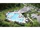 Aerial view of a community pool area with lounge chairs, umbrellas, and adjacent parking at 408 Rowe Way, Knightdale, NC 27545