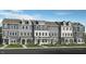 Row of newly built townhomes showing facade and design elements with professionally landscaped yards at 408 Rowe Way, Knightdale, NC 27545