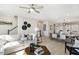 Open-concept living space with hardwood floors, stylish furniture, and seamless transition to the kitchen and dining area at 408 Rowe Way, Knightdale, NC 27545