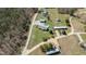 Aerial view showcasing a property with a pool, outbuildings and long driveway at 41 Rock Bluff Ln, Kittrell, NC 27544