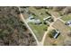 Expansive aerial view of a rural property with multiple structures and mature trees at 41 Rock Bluff Ln, Kittrell, NC 27544