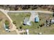 A high-angle aerial shot of a property featuring a home with a pool and multiple outbuildings at 41 Rock Bluff Ln, Kittrell, NC 27544