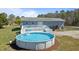 Backyard showcasing an above-ground pool with an attached deck, ideal for summer relaxation at 41 Rock Bluff Ln, Kittrell, NC 27544