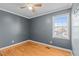 Inviting bedroom featuring hardwood floors, gray walls, and window for natural light at 41 Rock Bluff Ln, Kittrell, NC 27544