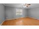 Neutral bedroom with hardwood floors, ceiling fan and a sunlit window at 41 Rock Bluff Ln, Kittrell, NC 27544