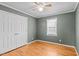 Cozy bedroom with hardwood floors, a ceiling fan, and double door closet for storage at 41 Rock Bluff Ln, Kittrell, NC 27544