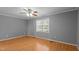 Neutral bedroom with hardwood floors, ceiling fan and a sunlit window at 41 Rock Bluff Ln, Kittrell, NC 27544
