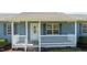 Close-up of the front porch with white railings and a decorative front door at 41 Rock Bluff Ln, Kittrell, NC 27544