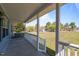 Covered front porch offering a relaxing outdoor space with views of the expansive lawn at 41 Rock Bluff Ln, Kittrell, NC 27544