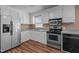 Well-lit kitchen with stainless steel appliances, and white cabinets at 41 Rock Bluff Ln, Kittrell, NC 27544