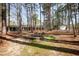 Large backyard with fire pit, mature trees, and space for outdoor activities and relaxation at 4105 Lassiter Rd, Wake Forest, NC 27587