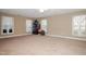 Spacious carpeted bedroom featuring many windows for natural light and a closet for storage at 4105 Lassiter Rd, Wake Forest, NC 27587