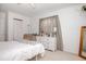 Bright bedroom featuring a white bed and dresser, complemented by a neutral color scheme and soft natural light at 4105 Lassiter Rd, Wake Forest, NC 27587