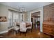 Formal dining room with wood table and upholstered chairs overlooking another living space at 4105 Lassiter Rd, Wake Forest, NC 27587