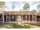 Inviting brick home featuring a covered porch with seating, enhancing the home's curb appeal at 4105 Lassiter Rd, Wake Forest, NC 27587