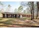 Expansive brick home with a long, covered porch, offering a welcoming outdoor space at 4105 Lassiter Rd, Wake Forest, NC 27587