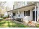 Charming home exterior with covered porch, mature landscaping, and inviting curb appeal at 4105 Lassiter Rd, Wake Forest, NC 27587