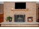 Close up of brick fireplace with stone hearth, decorative plants and screen at 4105 Lassiter Rd, Wake Forest, NC 27587