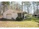 Detached garage and side yard offer ample space for storage or hobbies surrounded by mature trees at 4105 Lassiter Rd, Wake Forest, NC 27587