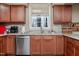 Kitchen sink and stainless steel dishwasher with wooden cabinets at 4105 Lassiter Rd, Wake Forest, NC 27587