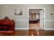 Open bedroom with neutral walls and view to the main bedroom providing natural light at 4105 Lassiter Rd, Wake Forest, NC 27587