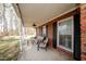 Relaxing covered porch with comfortable seating, perfect for enjoying the outdoors at 4105 Lassiter Rd, Wake Forest, NC 27587
