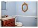 Stylish powder room with elegant vanity and fixtures, complemented by soft blue walls and sophisticated accents at 4105 Lassiter Rd, Wake Forest, NC 27587