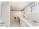 Tidy bathroom with a dual sink vanity, tiled walls, and combined tub/shower at 413 S Maple St, Graham, NC 27253