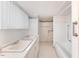 Clean bathroom featuring dual sink vanity, tile flooring and combined tub/shower at 413 S Maple St, Graham, NC 27253