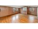 Expansive bedroom with hardwood floors, wood paneled walls, and natural light at 413 S Maple St, Graham, NC 27253