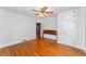 Neutral bedroom featuring hardwood floors and a ceiling fan at 413 S Maple St, Graham, NC 27253