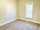 This bedroom features neutral carpeting, and a window at 45 Crabtree Ct, Fuquay Varina, NC 27526