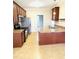 Well-lit kitchen with stainless appliances, dark brown cabinets, and plenty of space at 45 Crabtree Ct, Fuquay Varina, NC 27526