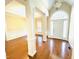 Bright foyer with gleaming hardwood floors, architectural columns, and modern lighting fixtures at 45 Crabtree Ct, Fuquay Varina, NC 27526