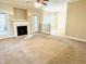 Inviting living room with fireplace and adjacent dining area with views of the outdoors at 45 Crabtree Ct, Fuquay Varina, NC 27526