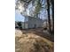 Exterior view of house with brick patio, light-blue siding, and sliding-glass doors to the backyard at 4610 Tyne Dr, Durham, NC 27703