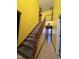 Bright yellow entryway with wood stairs and tile floors at 4610 Tyne Dr, Durham, NC 27703