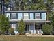Charming two-story home with light-blue siding, dark-green shutters, and landscaped front yard at 4610 Tyne Dr, Durham, NC 27703