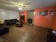 Cozy living room with stone fireplace, ceiling fan, and dark wood flooring at 4610 Tyne Dr, Durham, NC 27703