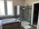 This bathroom features a modern glass shower, tub, and decorative mosaic tile at 465 Claremont Dr, Chapel Hill, NC 27516