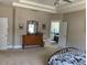 Bright bedroom featuring neutral carpet and trim with a matching dresser and a tray ceiling at 465 Claremont Dr, Chapel Hill, NC 27516