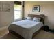 This cozy bedroom features a full sized bed, neutral colored walls, carpet, and trim at 465 Claremont Dr, Chapel Hill, NC 27516