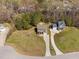 An aerial view showcasing a home with well-manicured lawns and a long driveway at 50 Yelverton Ct, Holly Springs, NC 27540