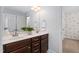 This bathroom includes double sinks, modern lighting, and elegant wood cabinets at 50 Yelverton Ct, Holly Springs, NC 27540