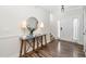 Inviting entryway with a console table, round mirror, and hardwood floors at 50 Yelverton Ct, Holly Springs, NC 27540